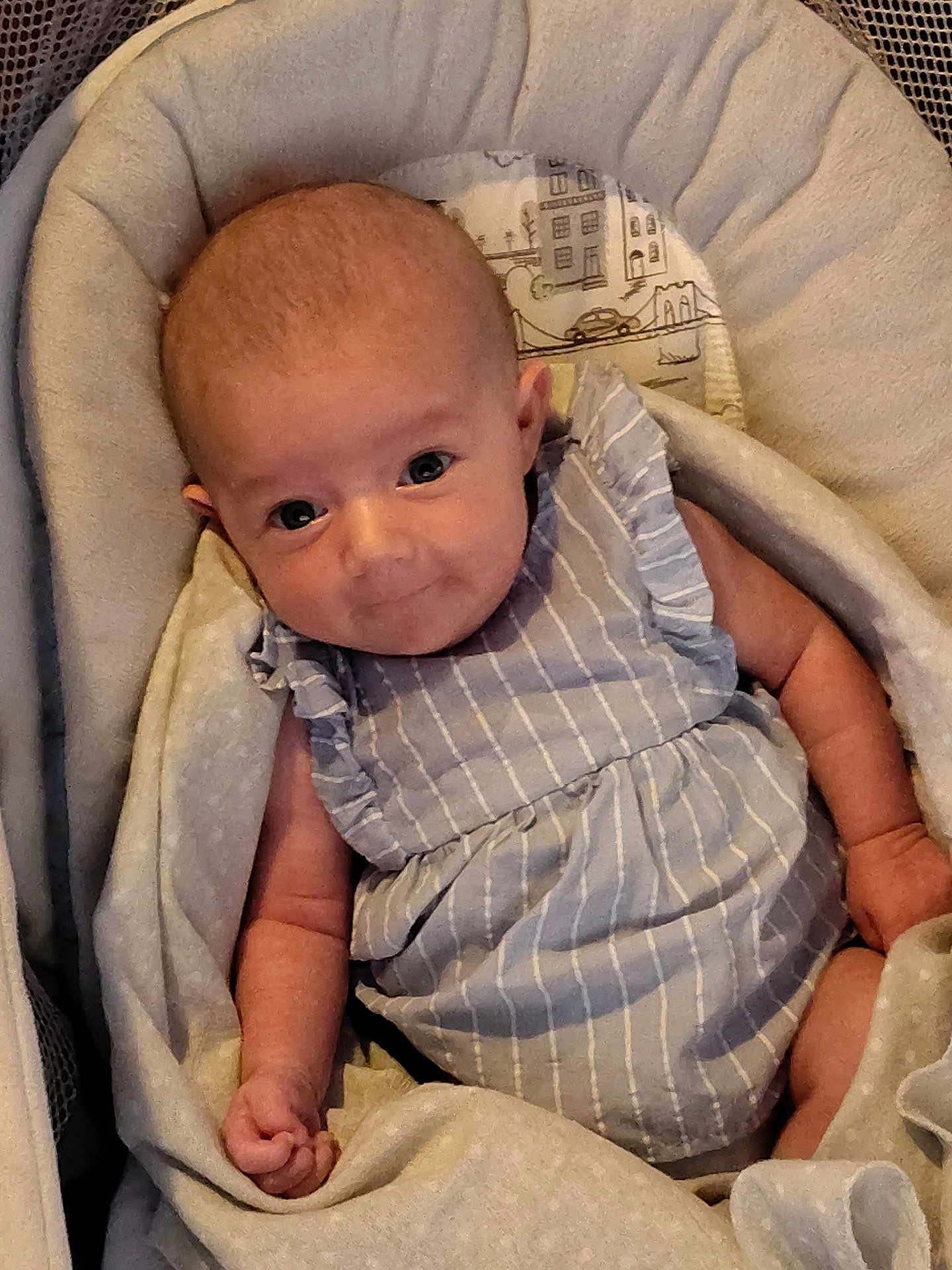 Everly joined the competition — help win amazing prizes! baby, infant, child, cushion, seat, clothing, dress, striped, cute, smiling, skin, face, hand, eyes, indoors, blanket, cozy, comfort, person, portrait