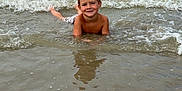 Isaac a rejoint le concours — aidez-le/la à gagner de superbes lots ! child, boy, water, sea, waves, beach, smiling, outdoor, summer, nature, ocean, sky, swimwear, wet, sand, reflection, shore, playing, young, happy