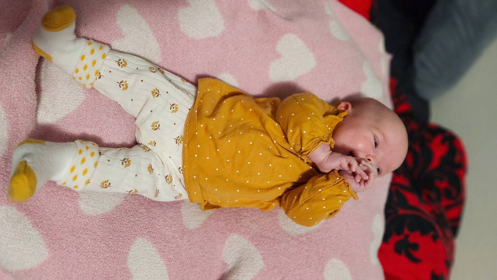 Annalise is registered to the contest to win money with this photo: baby, baby_products, baby_sleeping, baby_toddler_clothing, bedtime, child, comfort, event, hand, human_body, infant_bodysuit, linens, nap, pattern, person, pink, room, sleep, toddler