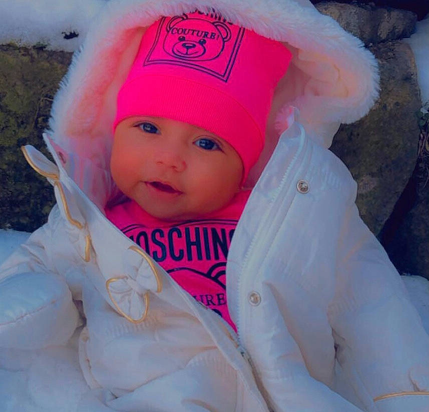 Loyalty is registered to the contest to win money with this photo: baby, baby_toddler_clothing, beanie, cap, eye, eyebrow, fashion_accessory, freezing, fur, happy, head, headgear, headwear, hood, knit_cap, magenta, person, pink, sleeve, toddler