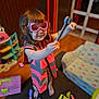 Charlie joined the competition — help win amazing prizes! child, pink_goggles, pink_safety_vest, tool, wrench, toy_tools, indoor, carpet, wooden_floor, play_kitchen, small_sofa, colorful, happy, smiling, barefoot, curly_hair, playtime, room, furniture, pretend_play