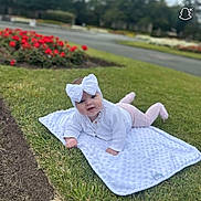 Willow joined the competition — help win amazing prizes! baby, child, blanket, grass, headband, outdoor, flower_bed, greenery, cute, infant, person, nature, park, soft_texture, white_clothing, pink_pants, smiling, toddler, daylight, portrait