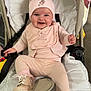 Willow joined the competition — help win amazing prizes! baby, child, smiling, pink_clothing, hat, stroller, footwear, socks, indoor, cushion, happy, person, infant, cute, warm_clothing, headwear, seated, portrait, baby_shoes, cozy