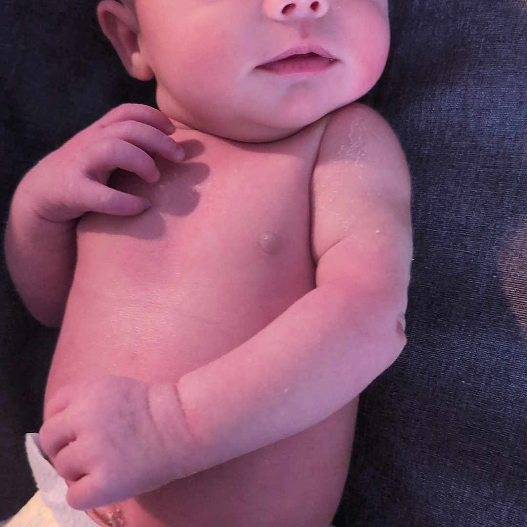 Reina is registered to the contest to win money with this photo: baby, child, closeup, curious, diaper, expression, fabric, face, hand, human, indoors, infant, lying_down, newborn, pacifier, pale_skin, portrait, skin, soft_lighting, texture