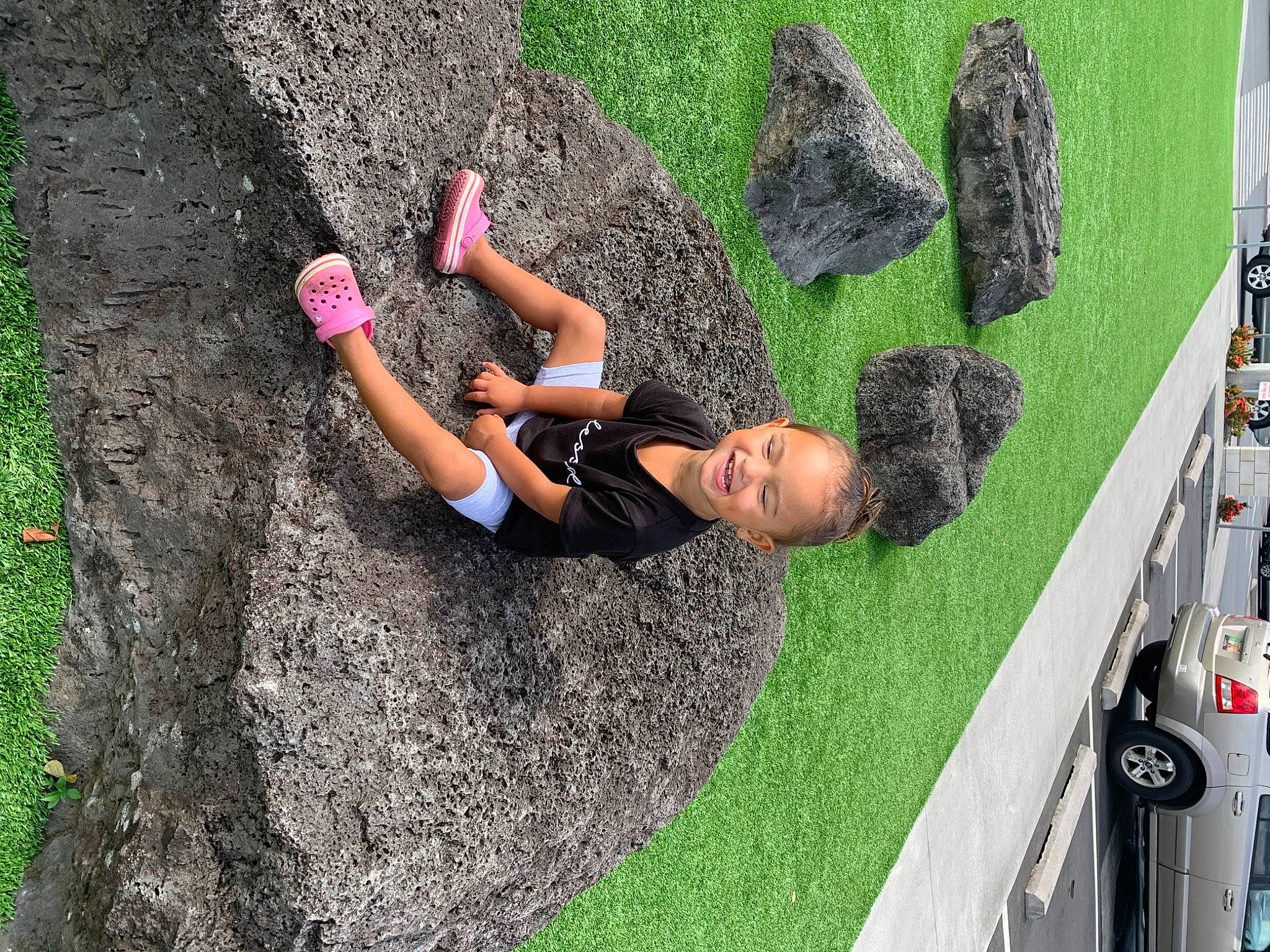 Marley Diamond is registered to the contest to win money with this photo: adventure, asphalt, car, climbing, concrete, fun, grass, knee, leisure, people_in_nature, person, plant, recreation, rock, shrub, soil, thigh, tire, tree, vehicle_door