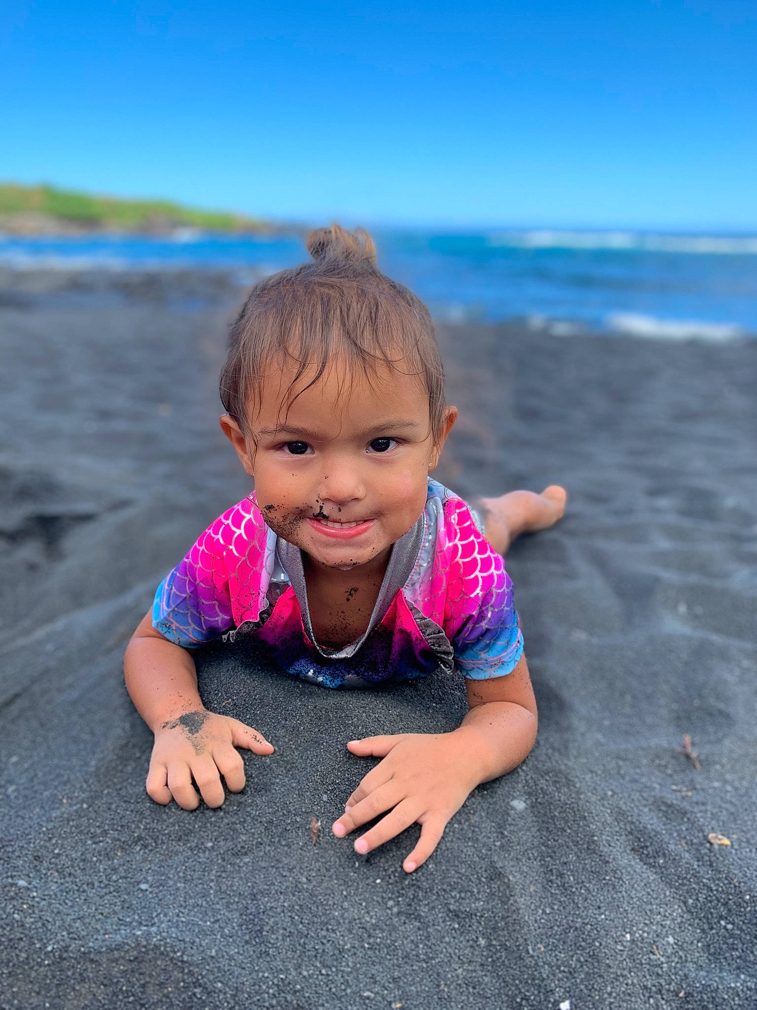 Marley Diamond is registered to the contest to win money with this photo: azure, beach, body_of_water, cloud, eye, face, flash_photography, fun, happy, head, horizon, joy, landscape, leisure, people_in_nature, person, sand, sky, smile, toddler