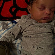 Laquell is registered to the contest to win money with this photo: baby, sleeping, onesie, blanket, soft, face, infant, child, cozy, cute, resting, peaceful, indoors, young, portrait, clothing, nap, toddler, comfort, closeup
