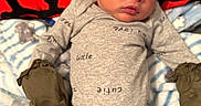 Laquell is registered to the contest to win money with this photo: newborn, baby, sleeping, onesie, mittens, blanket, soft, patterned_blanket, infant, lying_down, cozy, peaceful, indoors, cute, face, head, skin, tiny_hands, tiny_feet, red_background