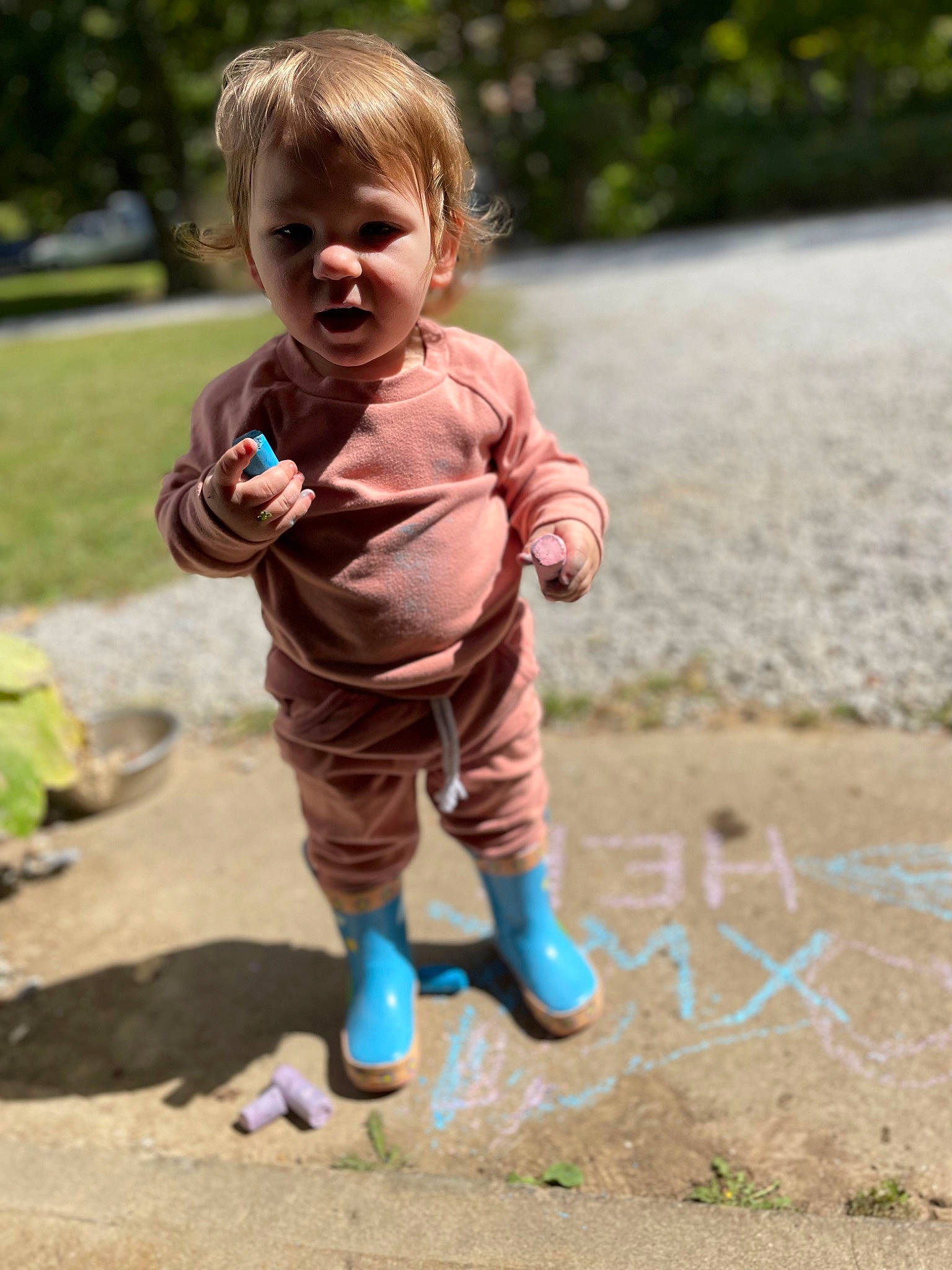 Harper is registered to the contest to win money with this photo: baby, baby_toddler_clothing, child, face, fun, grass, happy, leisure, outdoor_play_equipment, people_in_nature, person, plant, recreation, sand, sitting, smile, soil, toddler, tree, water