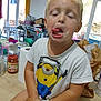 Inohé participe au concours pour gagner de l'argent avec cette photo : child, boy, silly_face, indoor, tshirt, minion, blond_hair, table, household_items, paper_towel, jar, window, curtain, plastic_chair, clothes, messy, tongue_out, closed_eyes, funny, casual