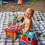 Idyle a rejoint le concours — aidez-le/la à gagner de superbes lots ! baby, child, toys, blanket, outdoor, pool, playtime, smiling, grass, fence, plastic_toy, infant, happy, diaper, colorful, yard, summer, fun, play, person