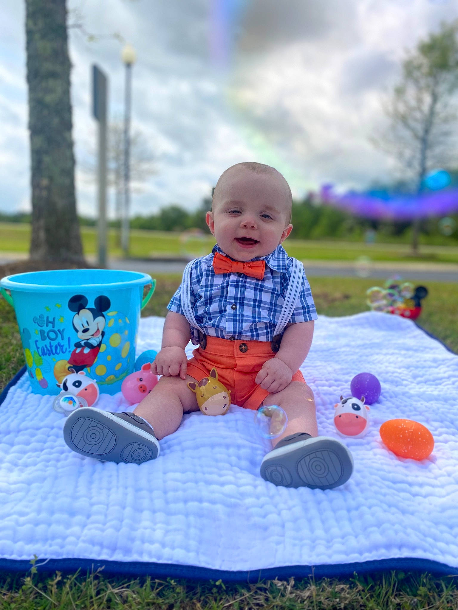 Kason joined the competition — help win amazing prizes! azure, baby, baby_toddler_clothing, blue, child, cloud, cup, event, fun, grass, happy, leisure, person, plant, recreation, shorts, sitting, sky, t_shirt, toddler