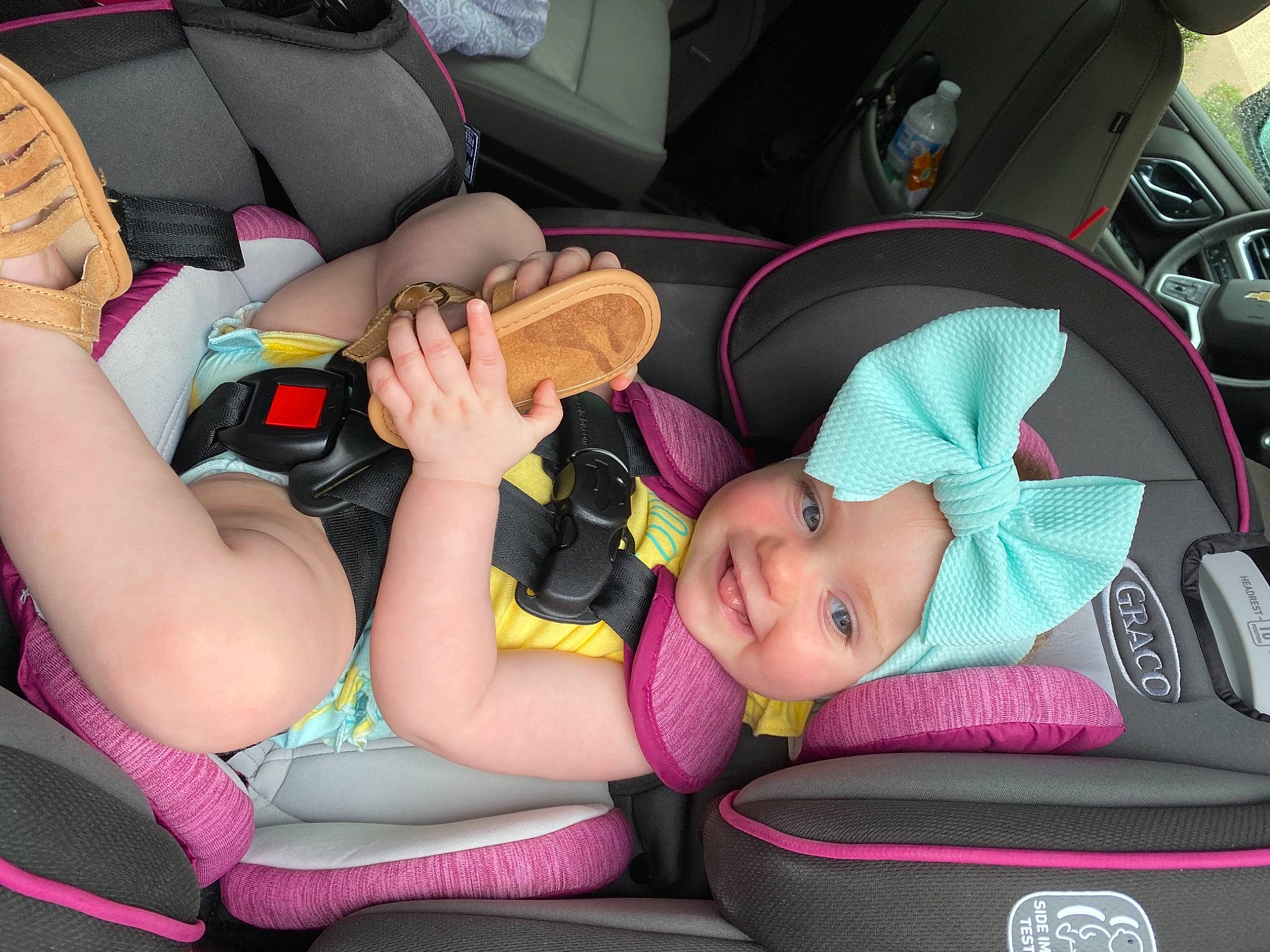 Madisyn is registered to the contest to win money with this photo: automotive_design, car, car_seat, car_seat_cover, child, comfort, facial_expression, fun, hat, head_restraint, headwear, human_body, joy, knee, lap, motor_vehicle, person, product, snapshot, thigh