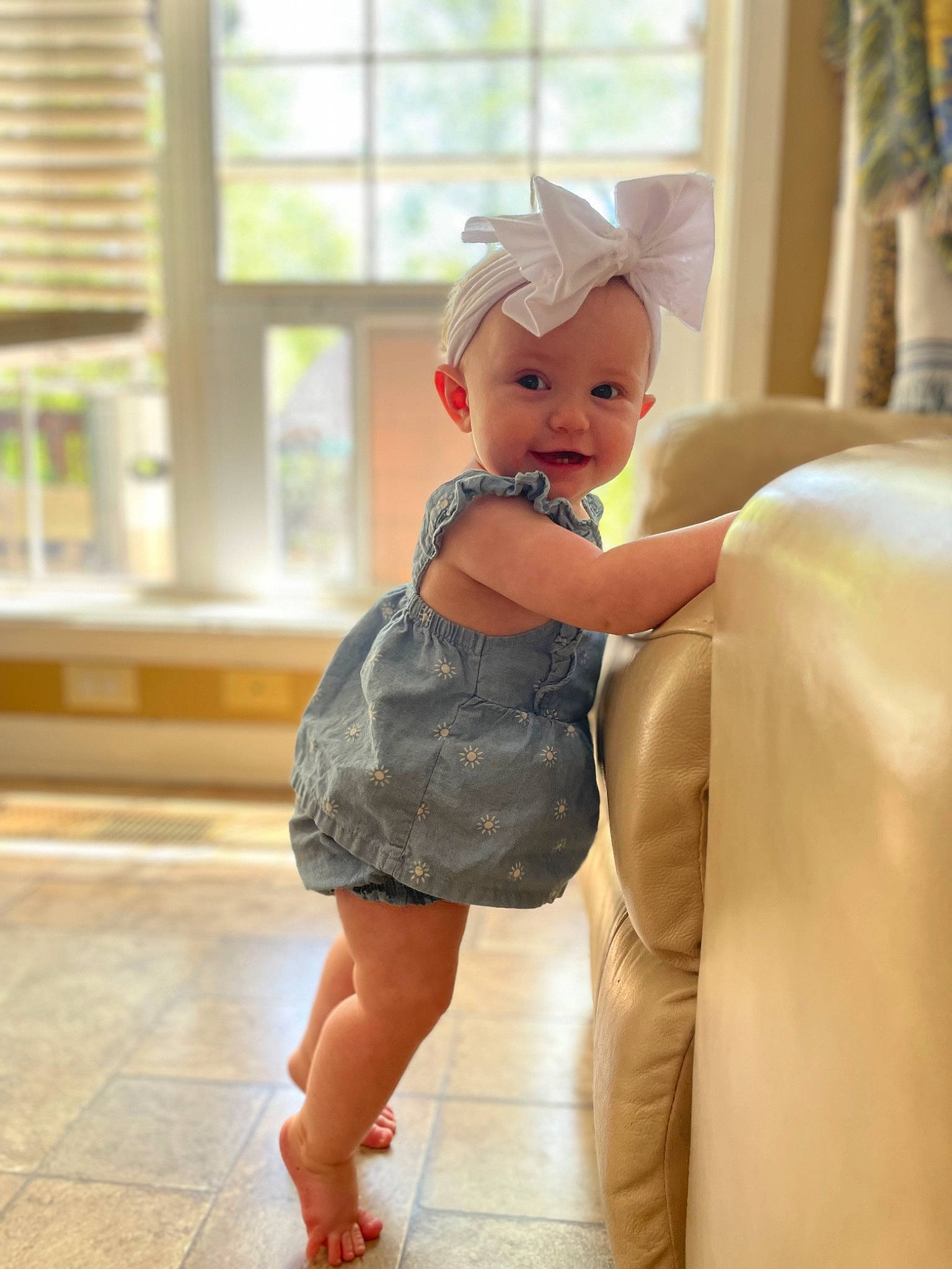 Adelynn is registered to the contest to win money with this photo: blond, child, doll, facial_expression, fashion_design, flooring, hairstyle, happy, human_leg, joint, one_piece_garment, peach, person, pink, skin, sleeve, toddler, toy, trunk, waist