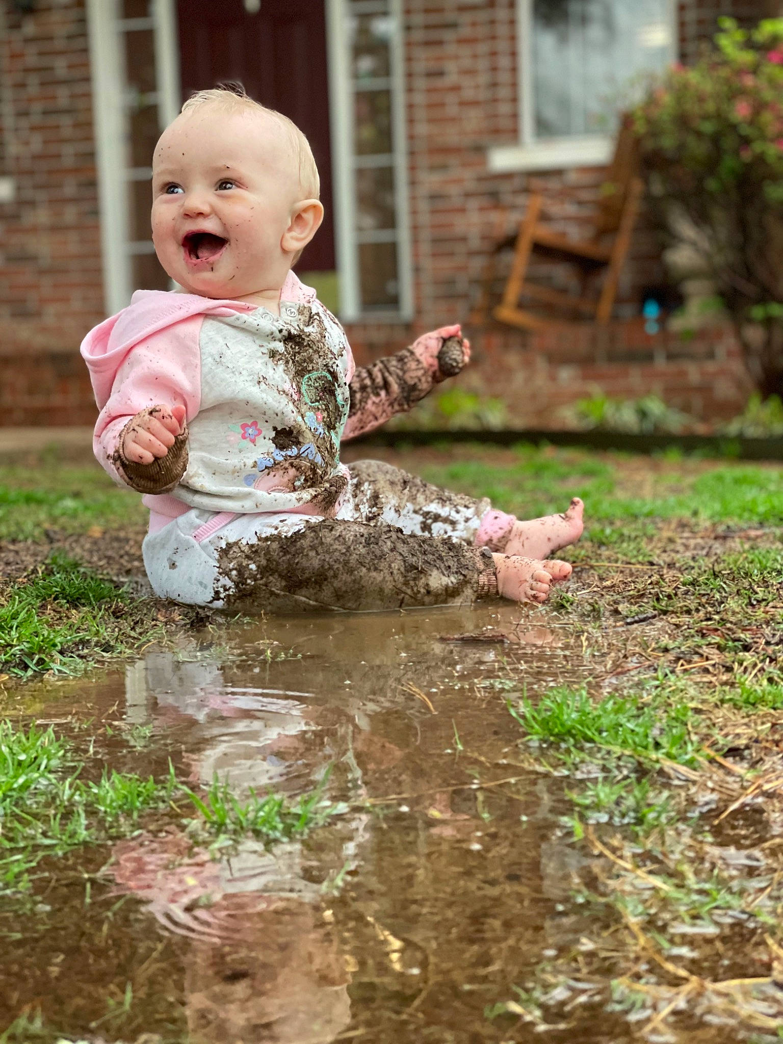 Adelynn joined the competition — help win amazing prizes! baby, baby_toddler_clothing, child, dress, face, flooring, fun, grass, grass_family, happy, leisure, people_in_nature, person, plant, puddle, sitting, smile, soil, toddler, water
