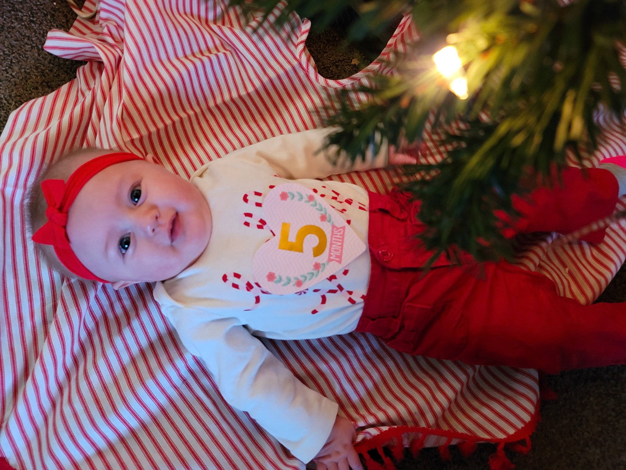 Rubyjean is registered to the contest to win money with this photo: baby, baby_toddler_clothing, cheek, child, christmas, christmas_decoration, christmas_eve, christmas_ornament, christmas_tree, conifer, fir, headwear, holiday, holiday_ornament, nose, ornament, peach, person, pink, skin