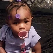 Amoura is registered to the contest to win money with this photo: braid, child, cornrows, face, female, girl, hair, head, person, pingpong, pingpongpaddle, racket, spitting, sport