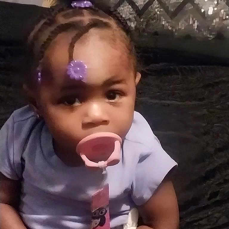 Amoura is registered to the contest to win money with this photo: braid, child, cornrows, face, female, girl, hair, head, person, pingpong, pingpongpaddle, racket, spitting, sport