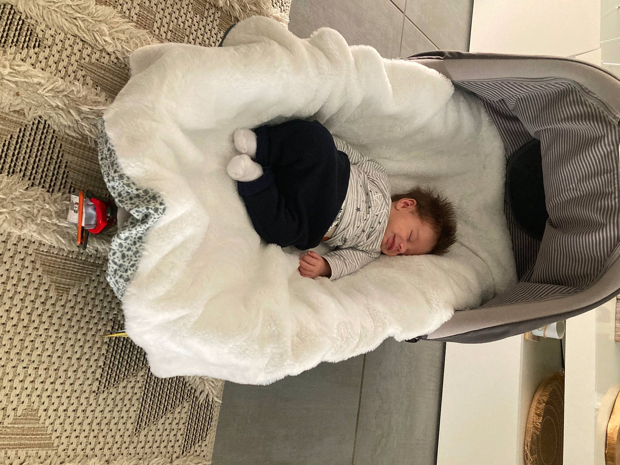 Soën participe au concours pour gagner de l'argent avec cette photo : arm, bedding, child, comfort, companion_dog, couch, flooring, fur, linens, nap, pattern, person, room, sitting, sleep, sleeve, tail, tree, wood, wool