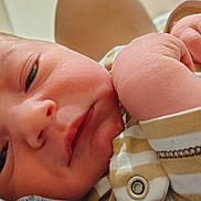 Dallas joined the competition — help win amazing prizes! baby, newborn, infant, face, hand, striped_clothing, close_up, skin, person, sleepy, portrait, young_child, cute, small_hand, soft_light, indoors, resting, newborn_clothes, baby_outfit, human