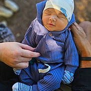 Nikolai is registered to the contest to win money with this photo: baby, sleeping, blue_outfit, hat, hands, striped_socks, infant, cozy, closeup, outdoor, natural_light, blurred_background, person, child, newborn, cute, soft_texture, resting, tiny_clothes, portrait