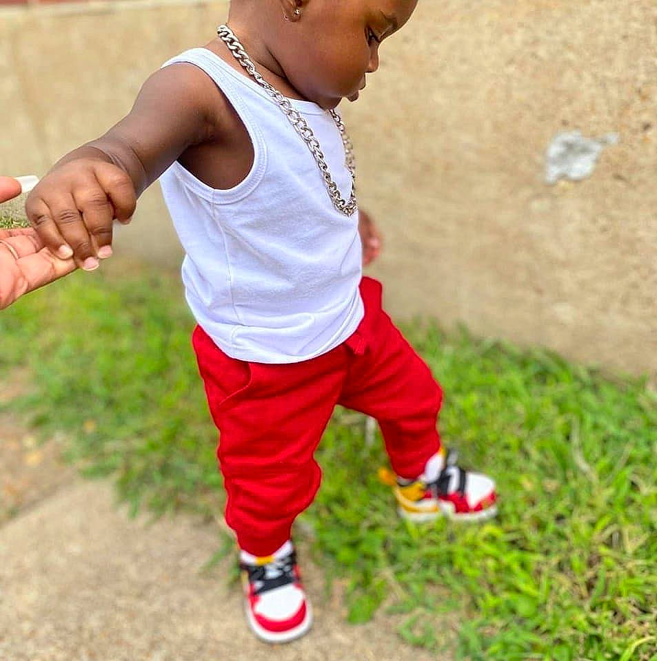 Kingston is registered to the contest to win money with this photo: active_pants, active_tank, baby_toddler_clothing, chest, clothing, electric_blue, grass, happy, human_leg, jersey, knee, person, shoulder, sleeve, sportswear, sweatpant, t_shirt, thigh, toddler, waist