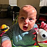 Auziel joined the competition — help win amazing prizes! baby, bib, blinds, child, clothing, colorful, curious, cute, expression, face, furniture, hand, indoor, person, play, room, smiling, toy, window, young