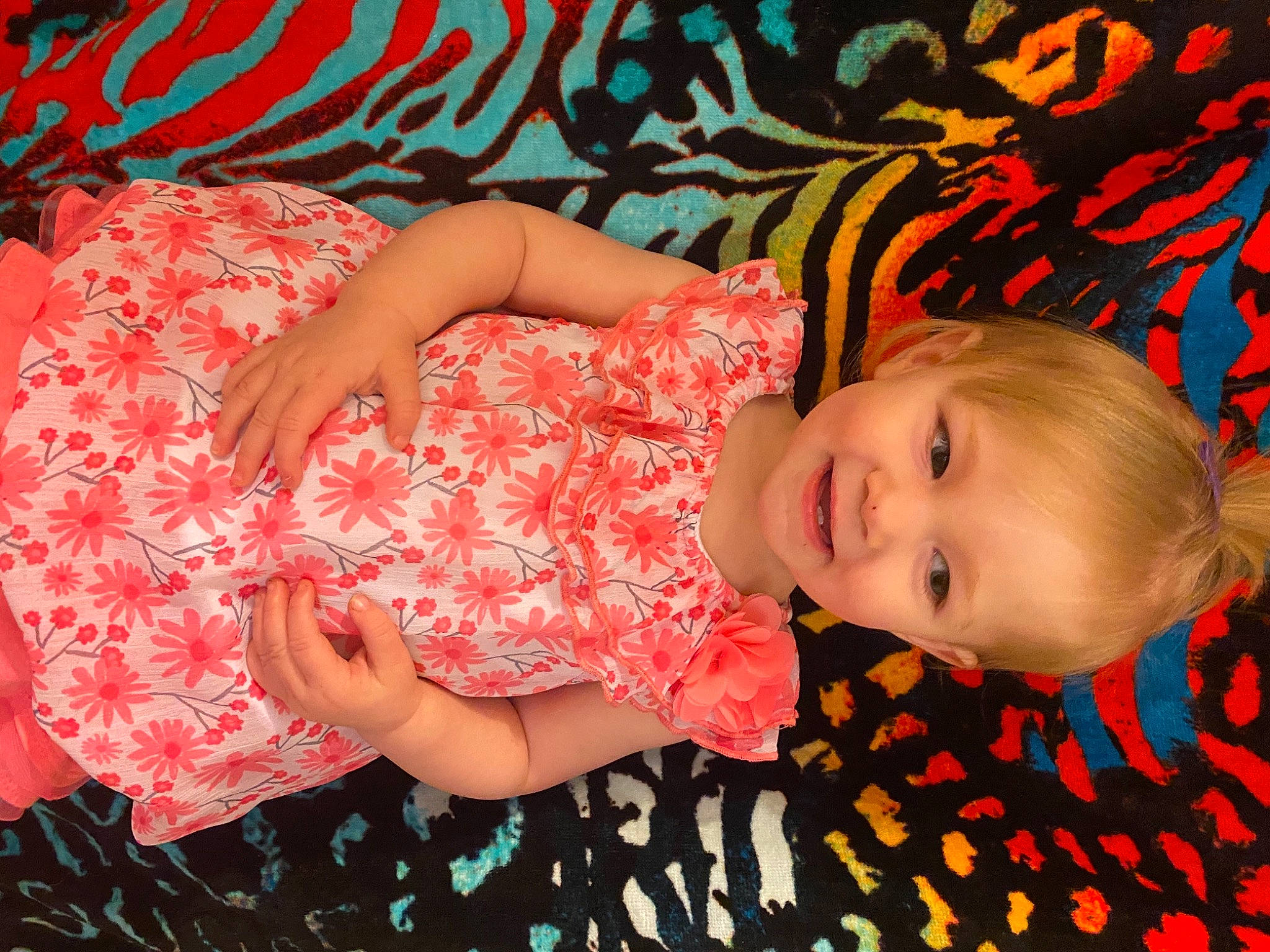 Ravena is registered to the contest to win money with this photo: baby_toddler_clothing, child, facial_expression, fun, happy, head, human_body, human_leg, joy, orange, pattern, peach, people_in_nature, person, pink, skin, smile, textile, thigh, toddler