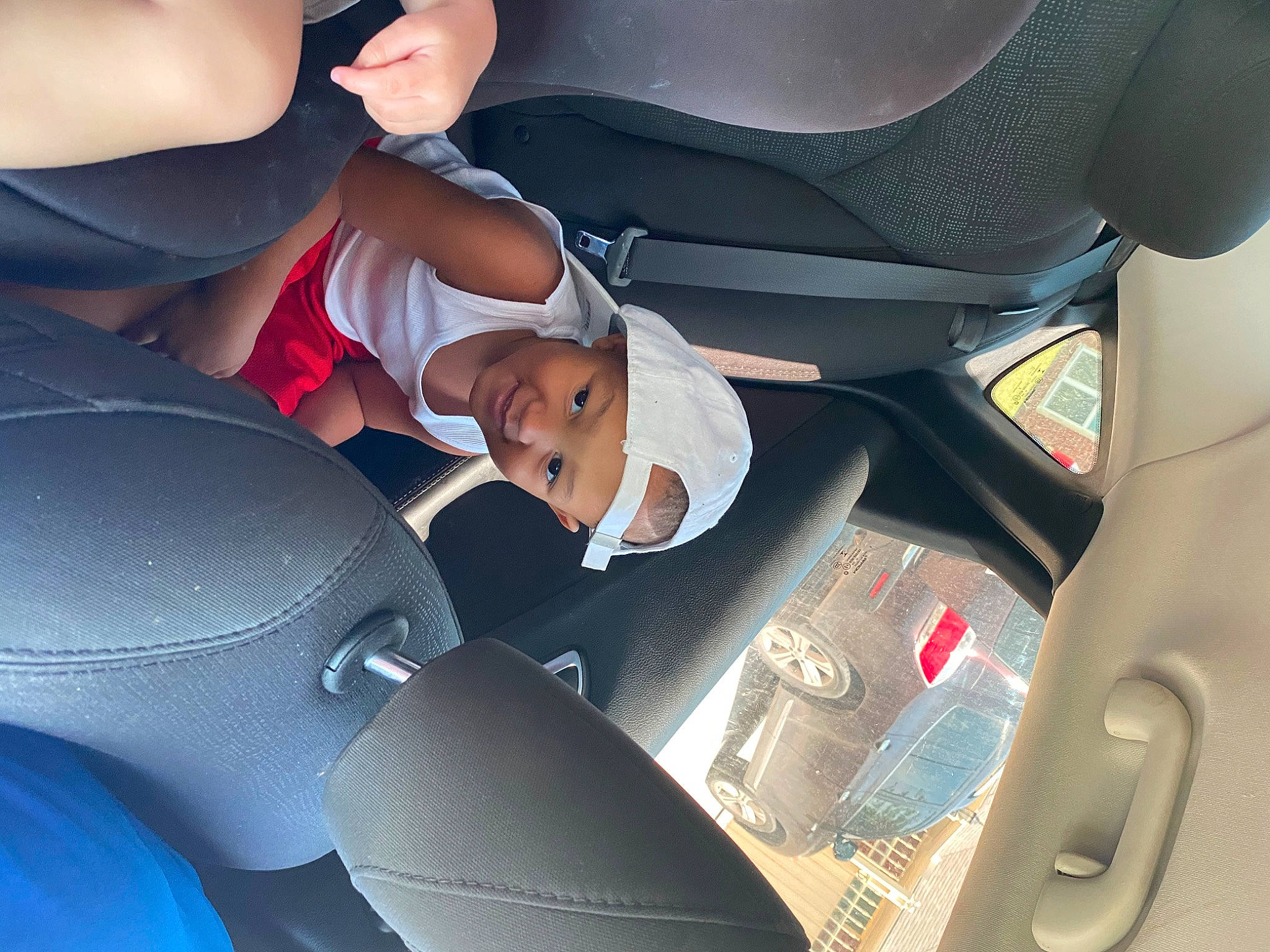Dj is registered to the contest to win money with this photo: auto_part, baby_in_car_seat, car, car_seat, car_seat_cover, driving, family_car, head_restraint, headwear, joy, person, seat_belt, vehicle