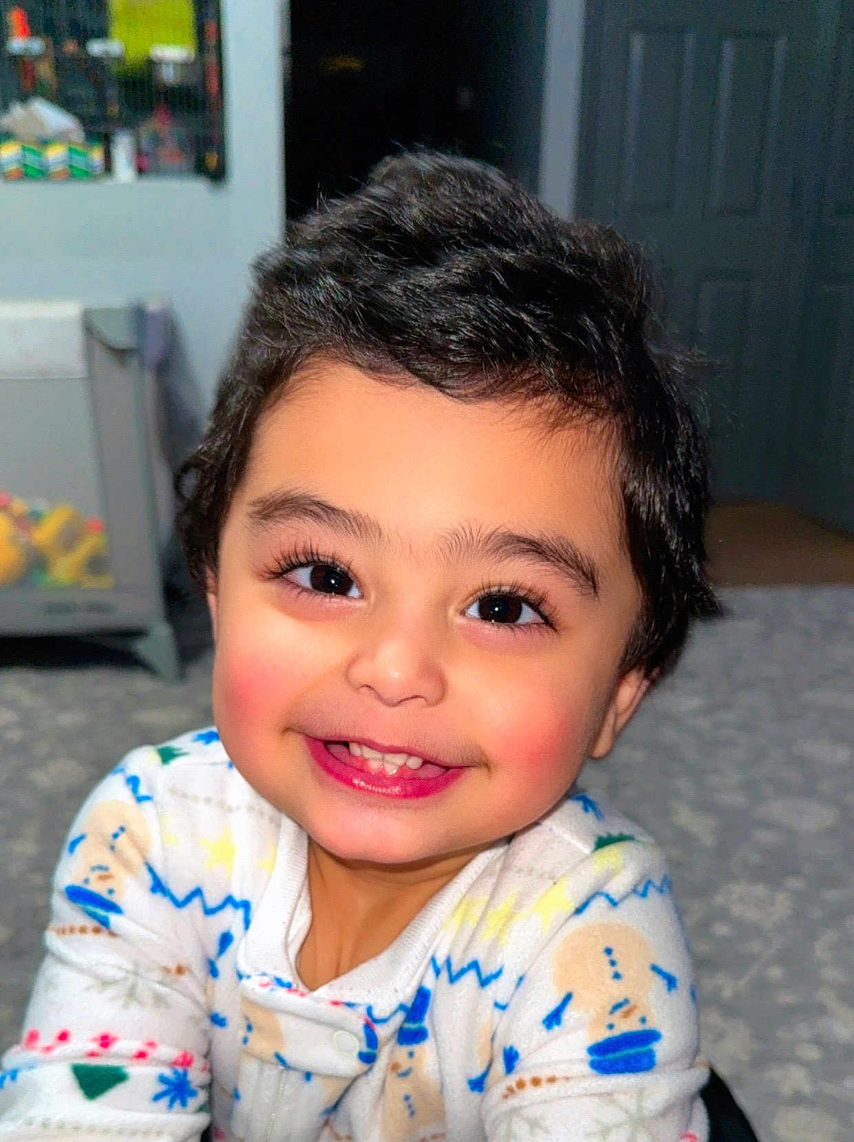 Sultan is registered to the contest to win money with this photo: baby, child, cozy, cute, expression, eyes, face, floor, hair, happy, indoors, infant, pajamas, person, playroom, portrait, rosy_cheeks, smile, toddler, warm_lighting
