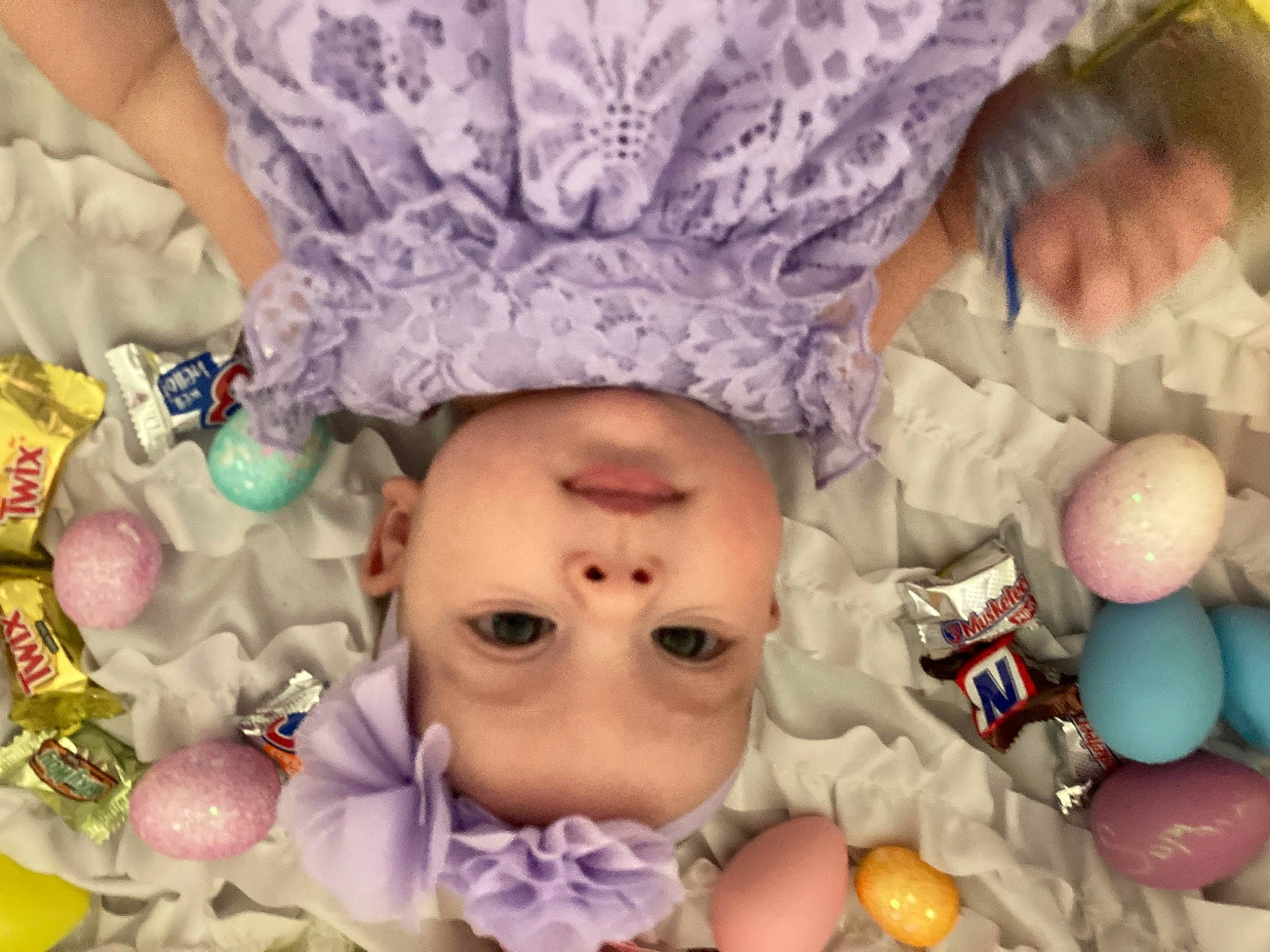 Sophia is registered to the contest to win money with this photo: cheek, eye, eyelash, face, facial_expression, fun, headgear, headwear, human, human_body, mouth, organ, person, photograph, pink, purple, skin, textile, toddler, toy
