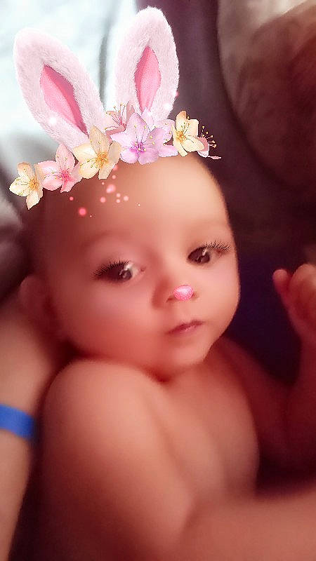 Ravyn is registered to the contest to win money with this photo: baby, beauty, cheek, child, close_up, eye, eyebrow, face, forehead, hair_accessory, hand, head, headgear, headpiece, headwear, iris, lip, organ, person, pink