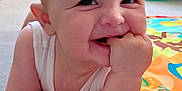 Jake is registered to the contest to win money with this photo: arm, baby, carpet, chewing, child, colorful, cute, fingers, happy, head, indoor, infant, mischievous, person, play_mat, room, skin, smile, soft, toy