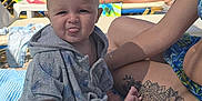 Jake joined the competition — help win amazing prizes! baby, child, hand, lounge_chair, outdoor, people, playful, poolside, relaxation, ring, summer, sunglasses, sunny, swimwear, tattoo, tongue_out, towel, umbrella, water, woman