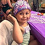 adult, background, celebration, child, clothing, crown, face, fun, girl, hair, happy, indoor, party, people, pose, purple, skin, smile, swimsuit, table