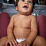Kai joined the competition — help win amazing prizes! baby, infant, diaper, skin, hands, belly_button, belly_ring, curly_hair, indoor, person, child, cute, exploring, sitting, casual, natural_light, relaxed, close_up, human, young