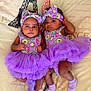 baby, twins, tutu, purple, headband, infant, blanket, eiffel_tower, cute, smiling, lying_down, matching_outfits, socks, adorable, child, portrait, indoor, colorful, playful, fashion