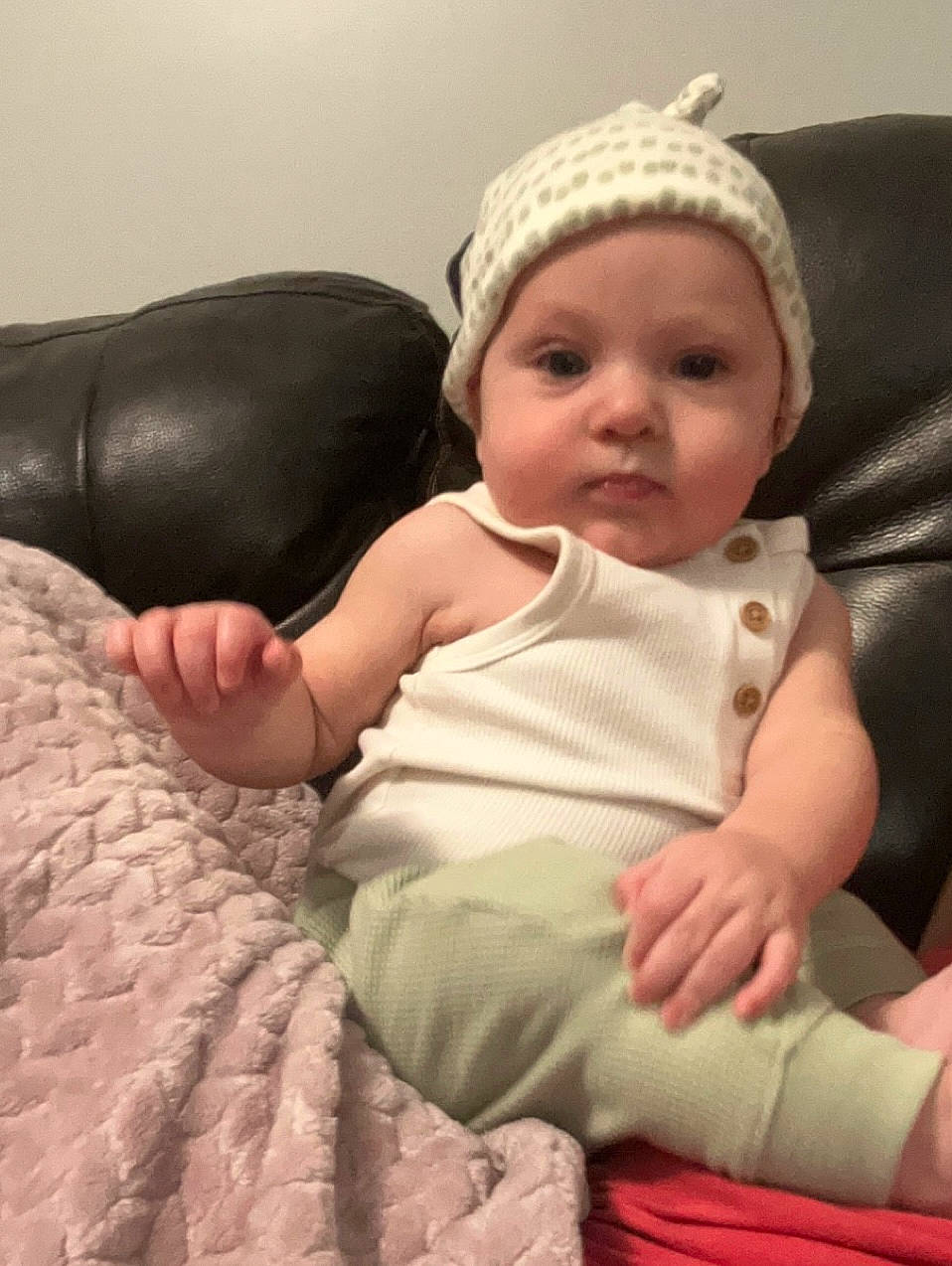 Ashton is registered to the contest to win money with this photo: baby, baby_sleeping, baby_toddler_clothing, beanie, cap, cheek, child, comfort, fashion_accessory, fur, headwear, human_leg, knit_cap, linens, person, room, sitting, skin, sleeve, sock