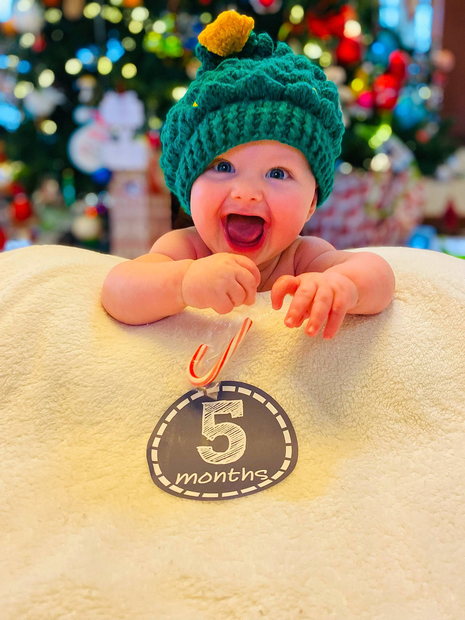 Luke is registered to the contest to win money with this photo: cap, christmas, christmas_decoration, christmas_ornament, costume_hat, event, fashion_accessory, fictional_character, gesture, happy, hat, headwear, holiday, holiday_ornament, human_body, ornament, person, plant, smile, thumb