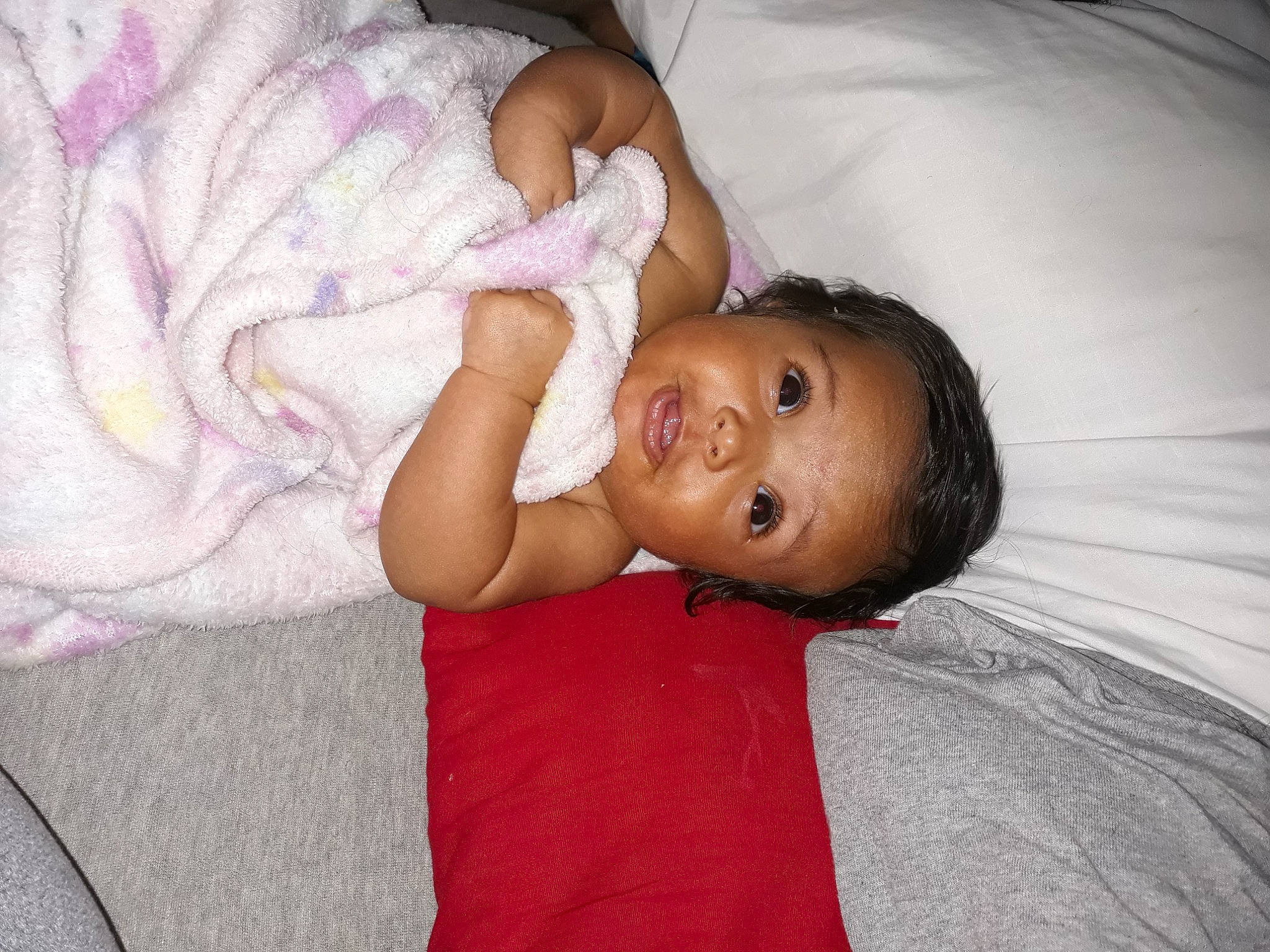 Tiana is registered to the contest to win money with this photo: baby, baby_products, baby_toddler_clothing, cheek, child, comfort, elbow, happy, human_body, iris, linens, lip, mouth, nail, nose, person, pink, skin, textile, thumb