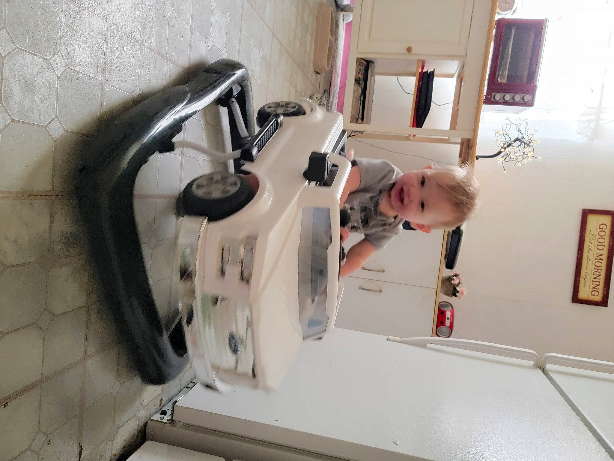 Alexander is registered to the contest to win money with this photo: arm, baby, building, home_appliance, household_appliance_accessory, machine, medical_equipment, person, picture_frame, room, science, service, t_shirt, toddler, window, wood