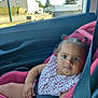 car_interior, car_seat, child, clothing, curly_hair, cute, daylight, face, hair_ties, indoor, looking_at_camera, pink, portrait, safety, seatbelt, sitting, sleeveless, toddler, window, young_child