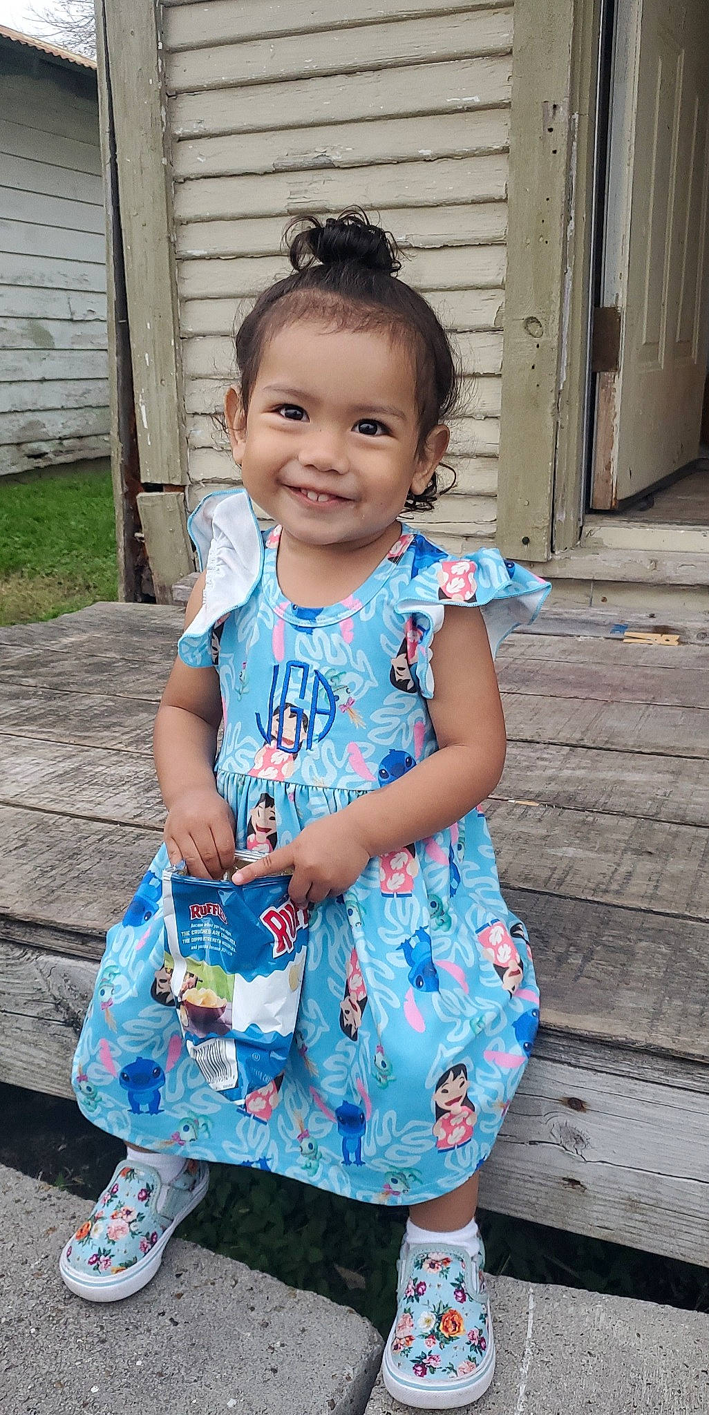 Jacklyn is registered to the contest to win money with this photo: azure, baby_toddler_clothing, blue, child, door, dress, electric_blue, hair, hairstyle, happy, joy, pattern, person, pink, purple, sandal, skin, sleeve, smile, standing