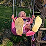 toddler, child, baby, swing, playground, outdoor, smiling, happy, swinging, ropes, shoes, shoe_sole, pink, grass, backyard, wooden_playset, playground_equipment, summer, portrait, laughter