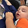 Ronnie joined the competition — help win amazing prizes! toddler, child, sleeping, orange_shirt, tattoo, arm, adult, indoor, chair, person, casual_clothing, denim_shorts, relaxation, comfort, nap, close_up, skin, face, hand, rest