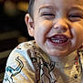 Ronnie is registered to the contest to win money with this photo: toddler, child, smiling, laughing, face, teeth, short_hair, dinosaur_shirt, clothing, happy, cute, portrait, close_up, indoor, person, baby, young_child, casual, joy, expression