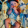 Cyrus is registered to the contest to win money with this photo: baby, infant, child, cap, orange_cap, romper, animal_print, toy_carrot, blanket, winnie_the_pooh, baby_seat, chewing, cute, chubby, indoor, portrait, happy, smiling, five_months, clothing