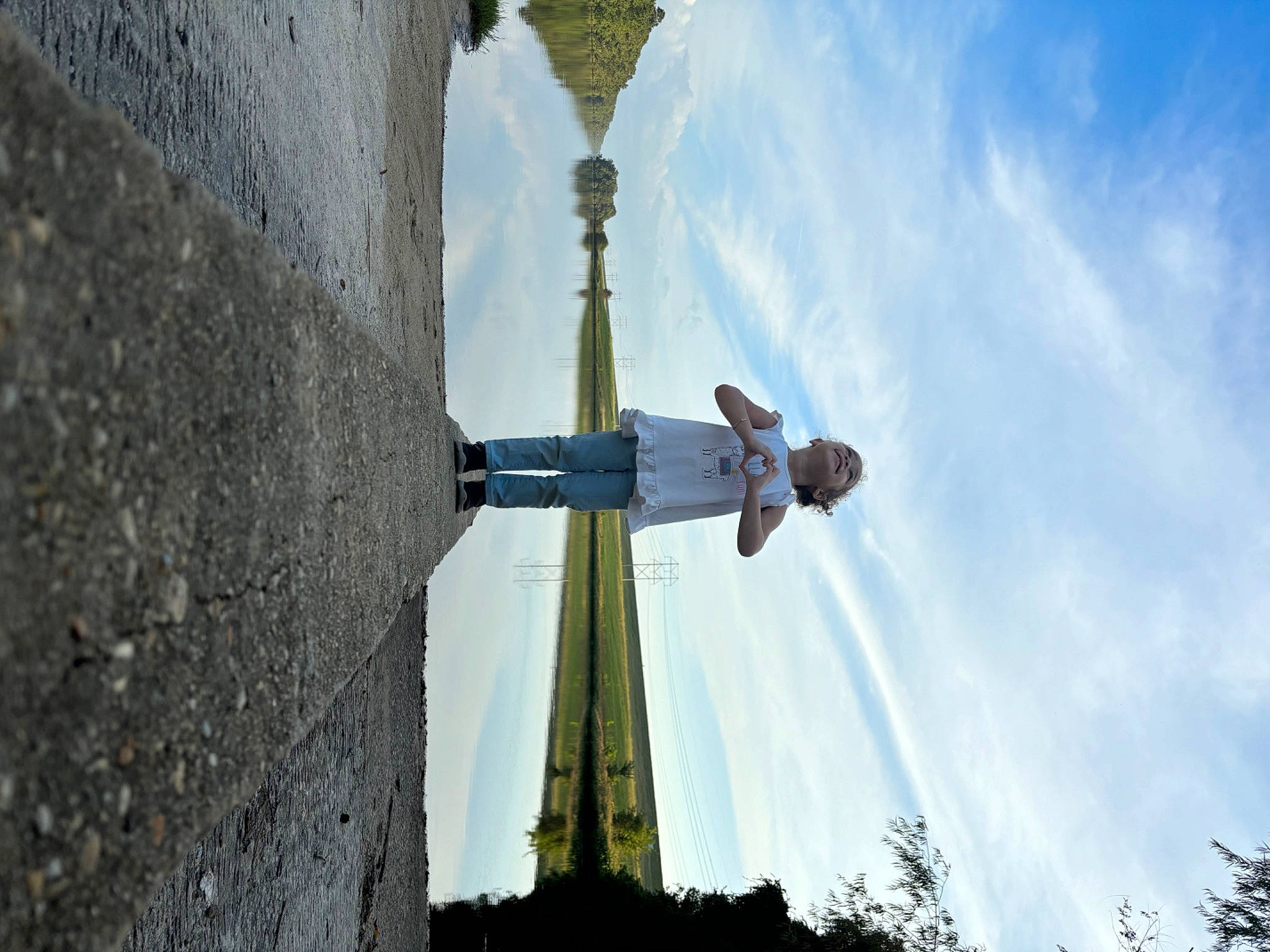 Arielle is registered to the contest to win money with this photo: architecture, art, building, city, cloud, cross, light_fixture, monument, person, plant, pole, public_utility, religious_item, sculpture, shadow, sky, statue, street_light, symbol, tree