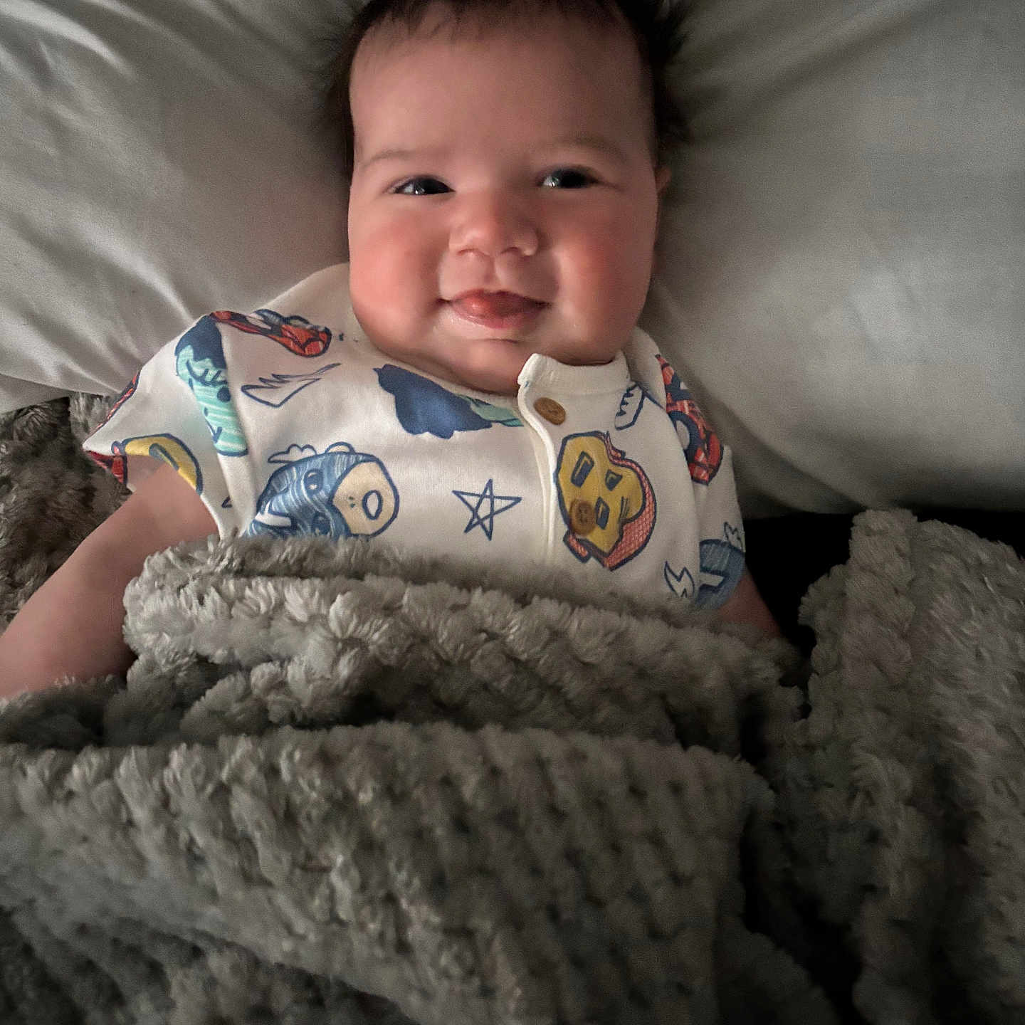 Noah is registered to the contest to win money with this photo: baby, babylaughing, bed, blanket, bodypart, couch, cushion, face, finger, furniture, happy, head, homedecor, laughing, newborn, person, photography, portrait, quilt, smile