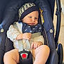 baby, car_seat, infant, hat, bib, stripes, legs, toes, hands, blanket, straps, buckles, outdoor, steps, curious, child, person, clothing, seat, footwear